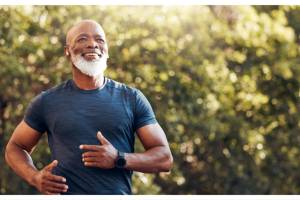 Man running through woodland