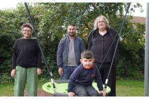 Standing are Leisa Taylor; Rayan’s father Zerivan Miru; Rayan Sney sat on the nest swing; Councillor Robyn Norfolk