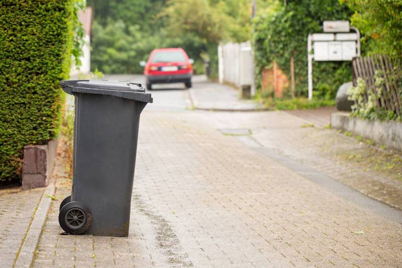 black wheely bin left out for collection