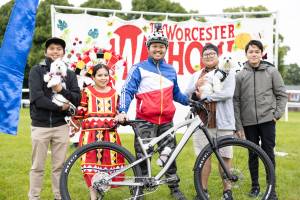 Members of the Worcester England Filipino Association in front of a Worcester Show banner