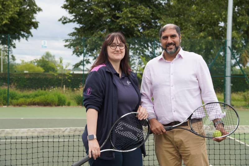 Lisa Kordas and Jabba Riaz holding tennis equipment