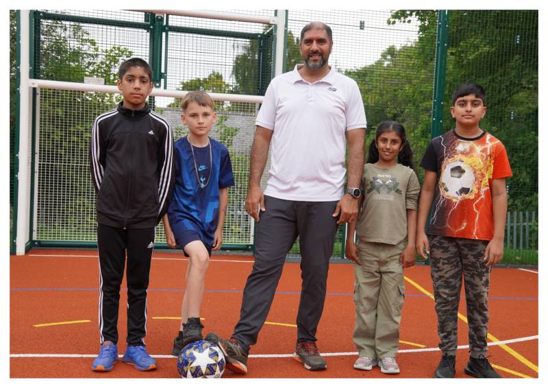 Four children and councillor Jabba Riaz at the multi-use games area at the Horizon Hub